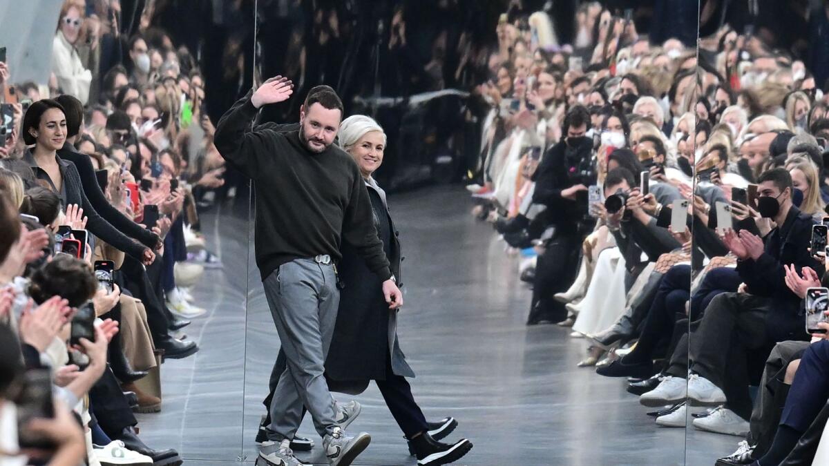 British fashion designer Kim Jones (L) and Italian fashion designer Silvia Venturini Fendi (R) acknowledge the audience after the Fendi catwalk show for the Women Fall/Winter 2022/2023 collection on the second day of the Milan Fashion Week in Milan on February 23, 2022.  Photo: AFP