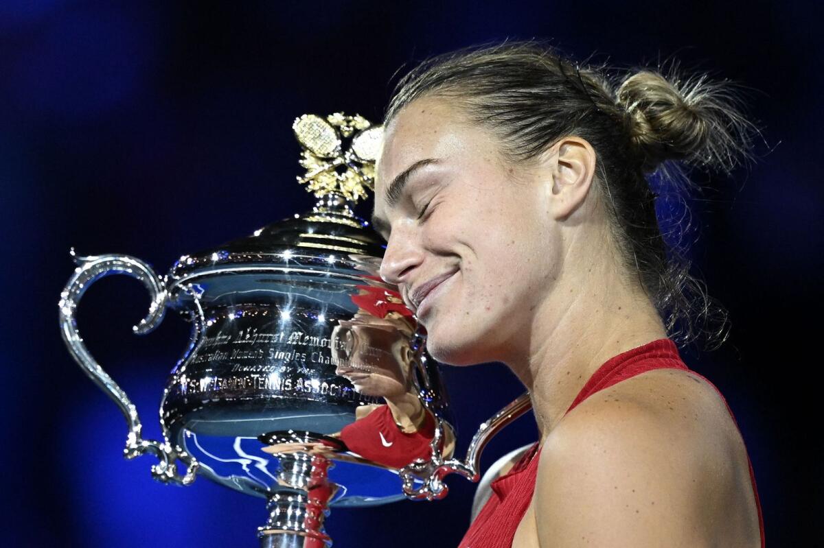 Belarus' Aryna Sabalenka hugs the Daphne Akhurst Memorial Cup after her victory against China's Zheng Qinwen in the Australian Open women's final on Saturday. - AFP