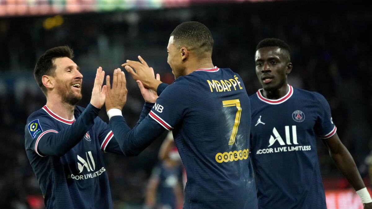 PSG's Kylian Mbappe (centre) celebrates with Lionel Messi (left) after scoring against Monaco at the Parc des Princes in Paris on Sunday. — AP