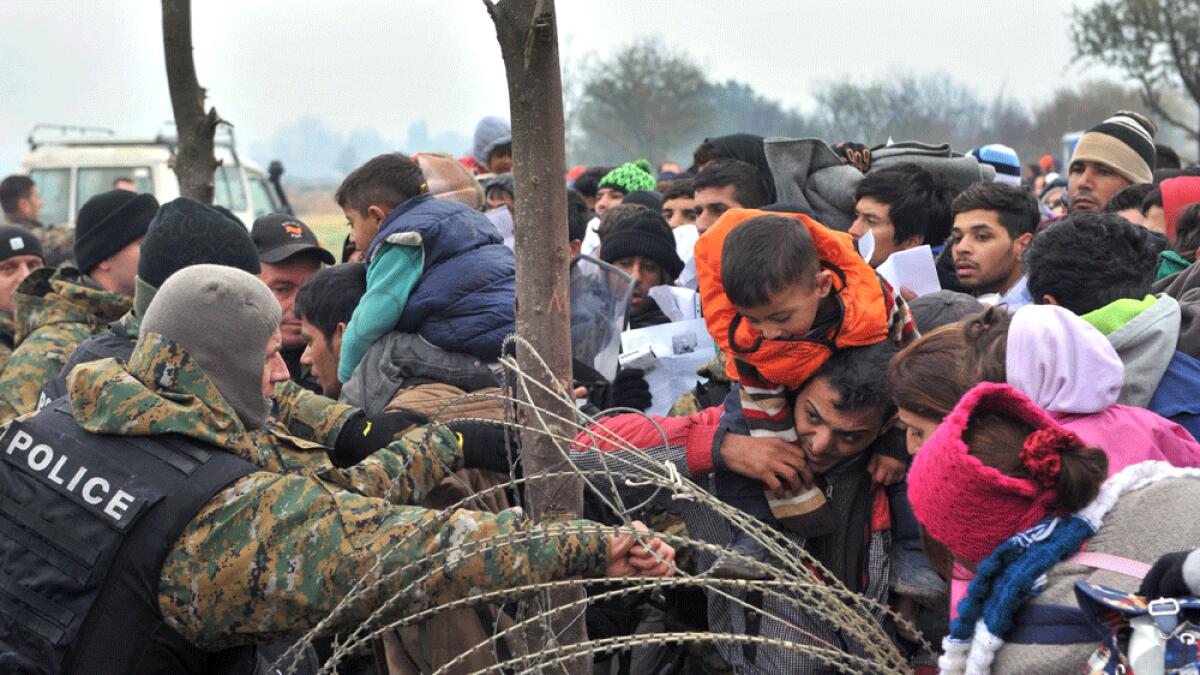 Migrants and refugees wait to cross the Greek-Macedonian border near the vilage of Idomeni.