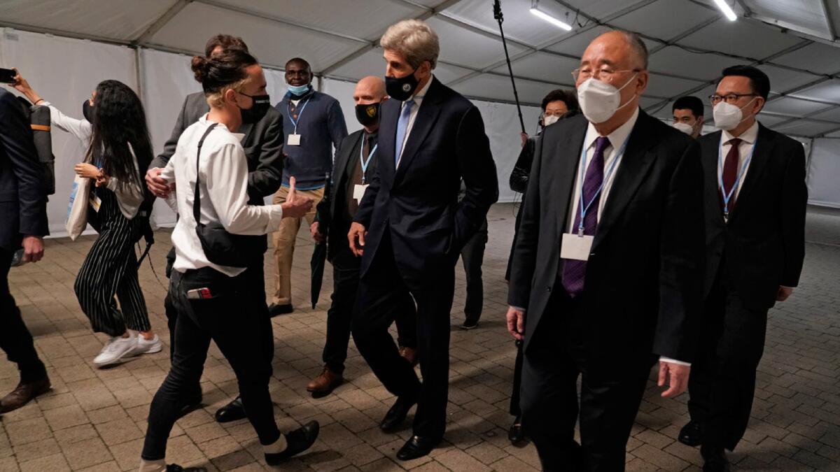 China's chief negotiator Xie Zhenhua walks with John Kerry, US Special Presidential Envoy for Climate at the COP26 UN Climate Summit in Glasgow, Scotland. – AP