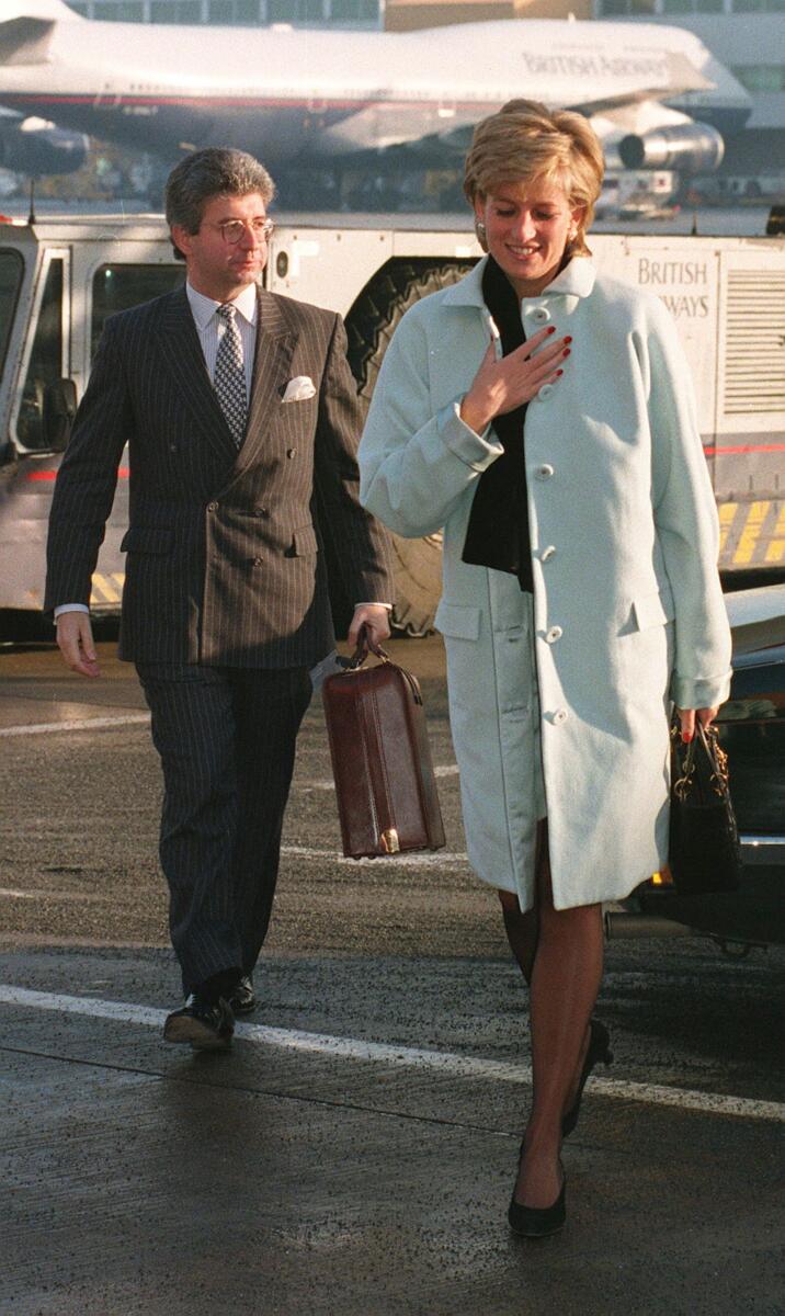 AP file photo shows Princess Diana with her private secretary, Patrick Jephson, at Heathrow Airport in London, in 1995.