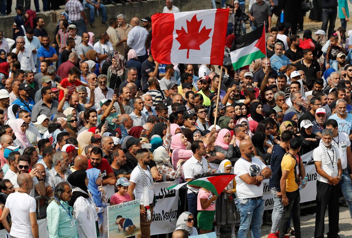 Hundreds of Palestinian refugees waving Palestinian and Canadian flags request asylum at a rally outside the the Canadian Embassy, in Beirut, Lebanon, Thursday, Sept. 5, 2019. People in the Gaza Strip who have Canadian relatives may apply for temporary visas to Canada, Canada’s immigration minister said Thursday, Dec. 21, 2023. AP
