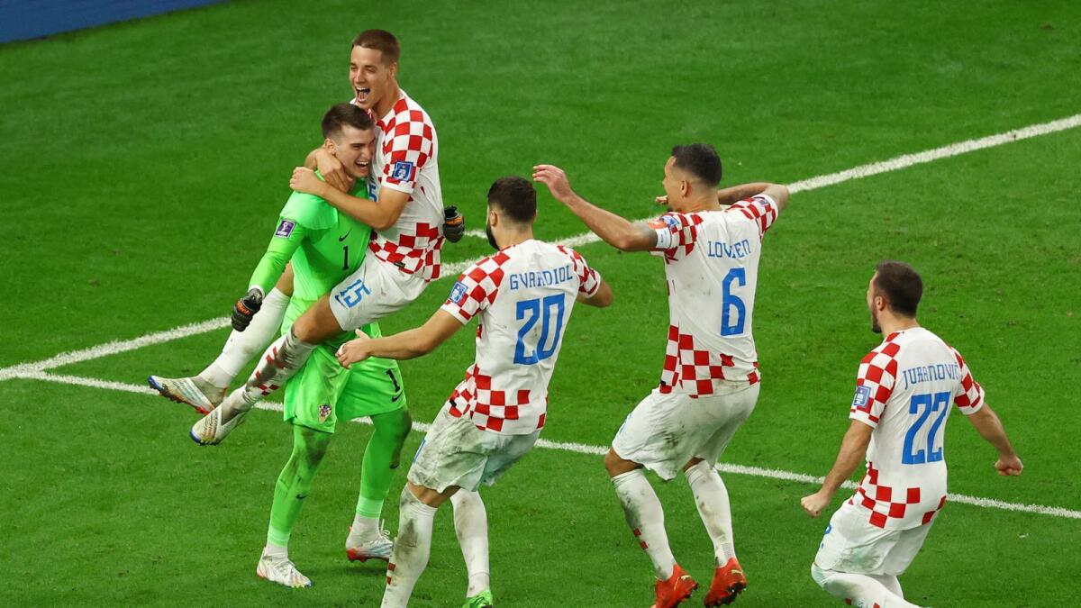 Croatia's Dominik Livakovic celebrates with Mario Pasalic, Josko Gvardiol, Dejan Lovren and Josip Juranovic after winning the penalty shootout and progressing to the quarter finals. Photo: Reuters