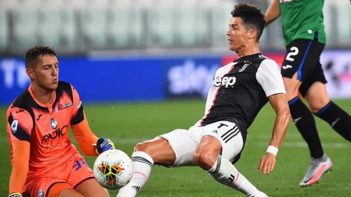 Juventus' Cristiano Ronaldo in action with Atalanta's Pierluigi Gollini. (Reuters)