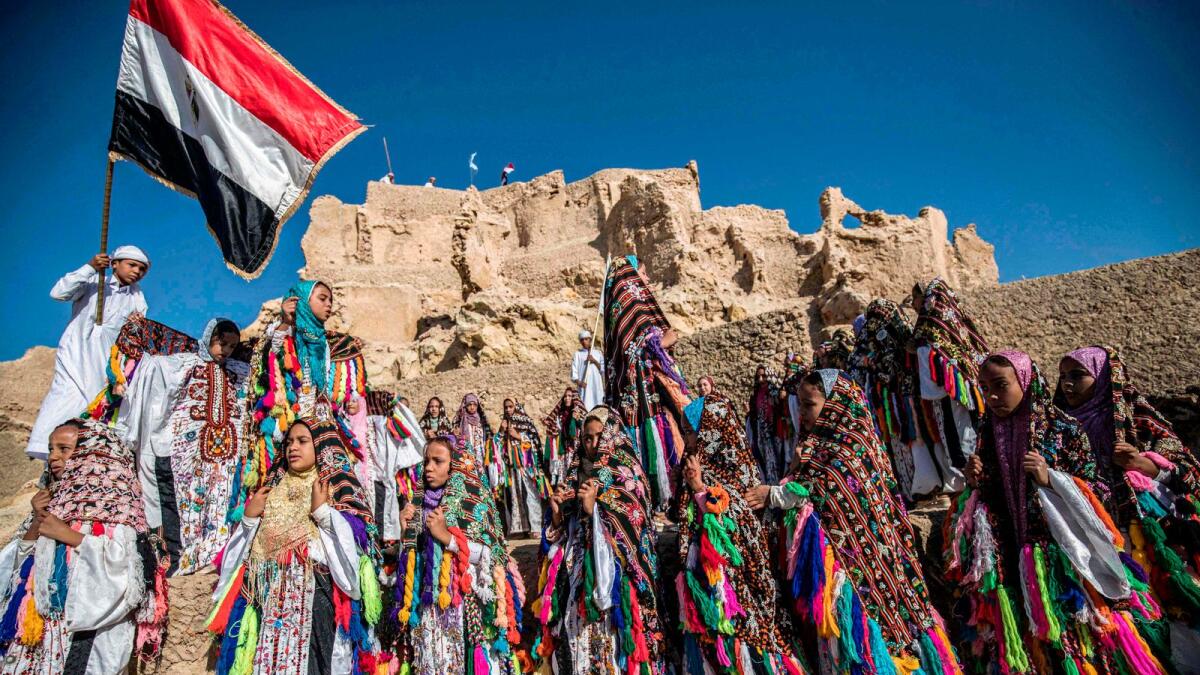 Egyptian school children dressed in traditional outfits, gather during a celebration to mark the inauguration of the fortress of Shali following its restoration, in the  desert oasis of Siwa, some 600km southwest of Cairo.