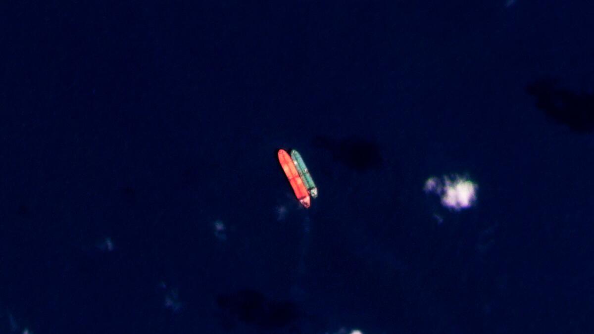 In this satellite photo provided by Planet Labs PBC, vessels identified as the Virgo, left, and the Suez Rajan, by the advocacy group United Against Nuclear Iran, are seen in the South China Sea. — AP file