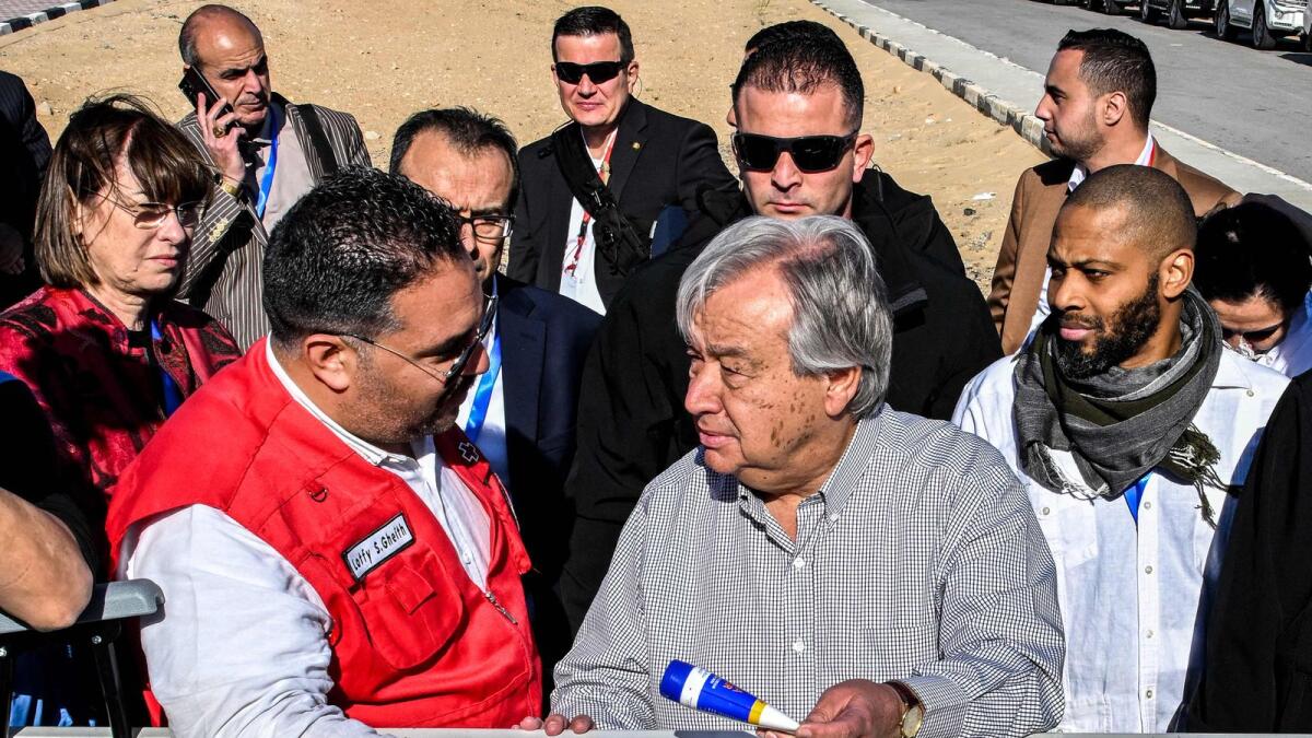 Lotfi Gheith, the emergency operations centre director for the Egyptian Red Crescent, briefs Antonio Guterres about items rejected by Israeli authorities that were bound for the Gaza Strip. — AFP