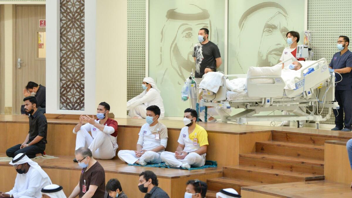 Long-term patients and their family members along with medical staff participate in the special Eid prayers