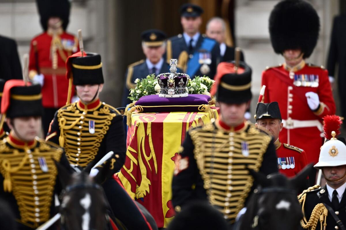 The coffin of Queen Elizabeth II, adorned with a Royal Standard and the Imperial State Crown and pulled by a Gun Carriage of The King's Troop Royal Horse Artillery. Photo: AFP