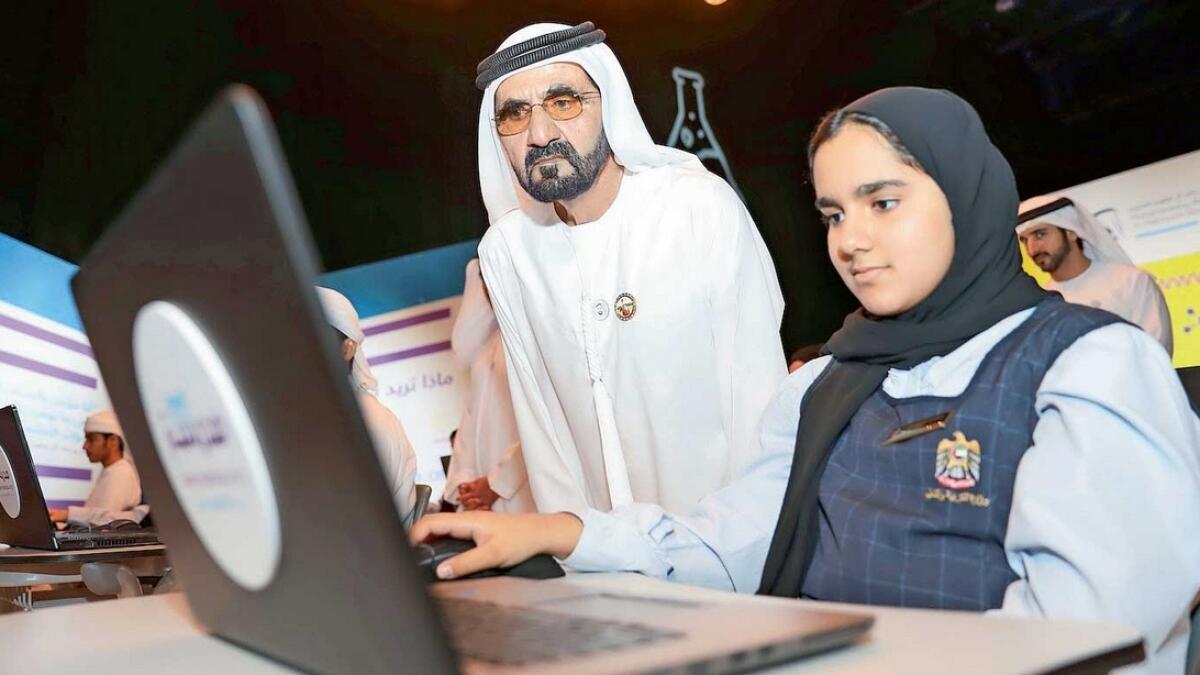 Sheikh Mohammed with a student during the launch of Madrasa e-learning platform in Dubai on Tuesday. — Wam