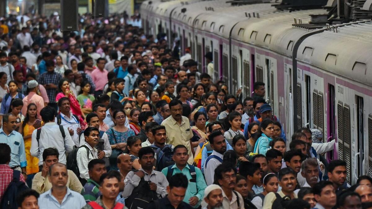 People crowd on platforms as they wait for their train at the Chhatrapati Shivaji Terminus railway station Mumbai. — AFP file