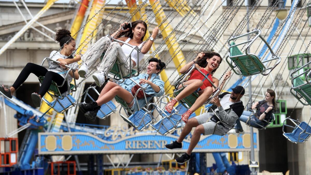 People ride on a merry-go-round on the Koenigssplatz square in Munich, Germany. Photo: Reuters