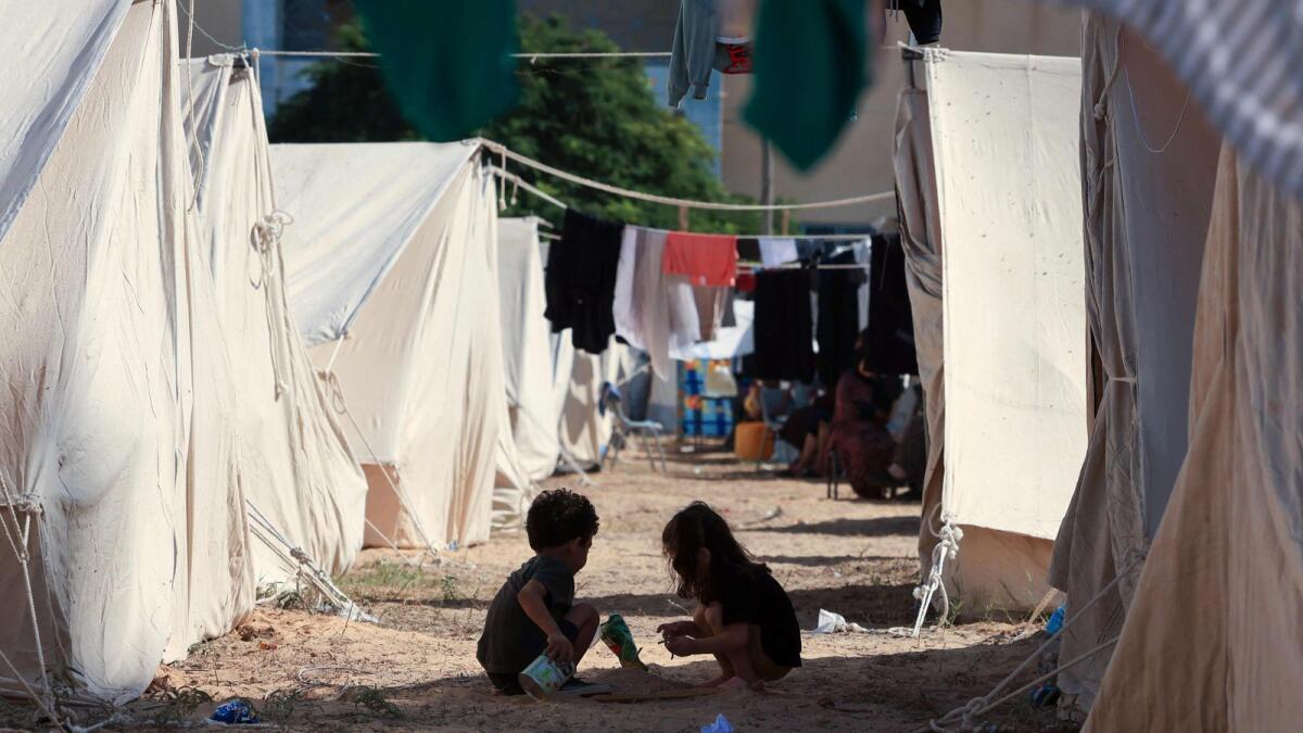 Children play among tents set up for Palestinians seeking refuge on the grounds of a United Nations Relief and Works Agency for Palestine Refugees (centre in Khan Yunis. Photo: AFP file