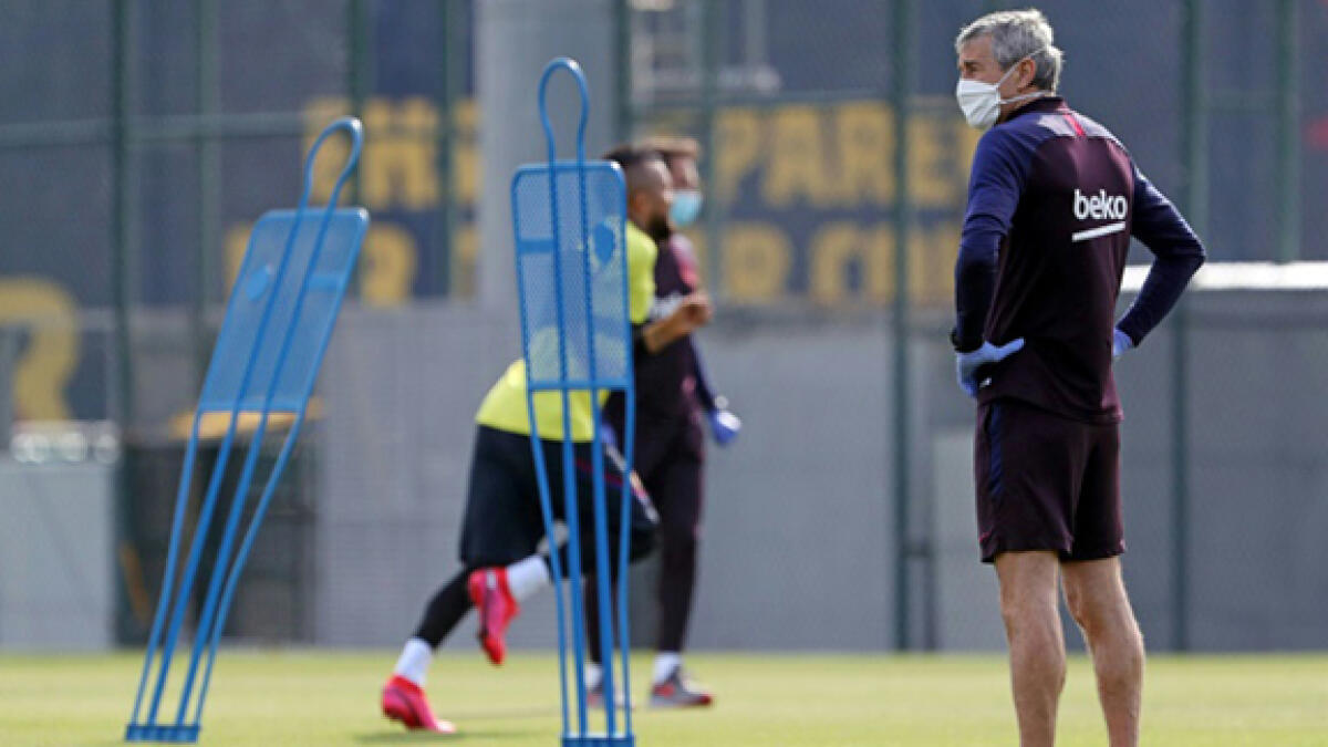 Barcelona coach Quique Setien and his squad resumed training on May 8. -- AFP