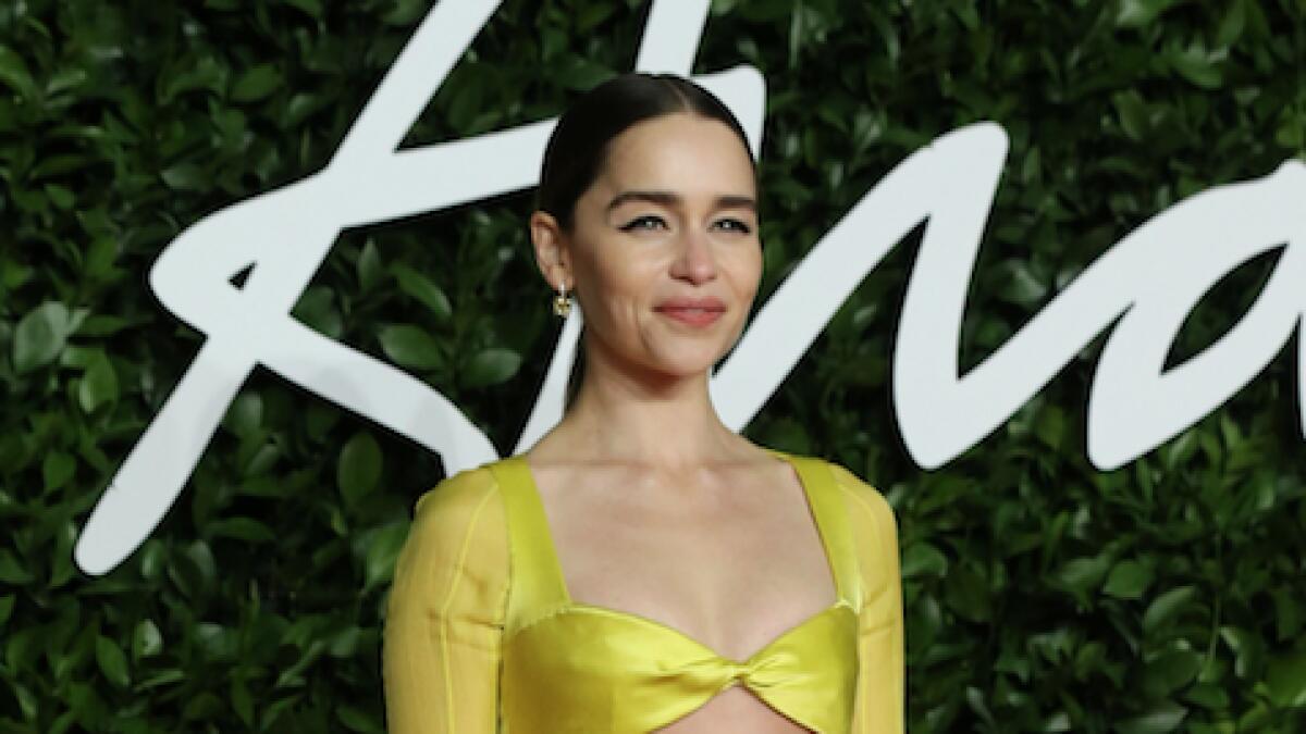 Game of Thrones star Emilia  Clarke turned heads in her rhinestone covered yellow dress with minimal goldaccessories. With a feathered cape and a voluminous sleeve the Schiaparelli Couture dress was a spot of sunshine on the red carpet.