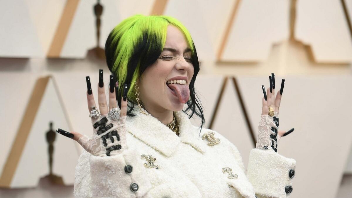 Billie Eilish donned fuzzy, oversize Chanel jackets and pants to go with her bright green and black hair.