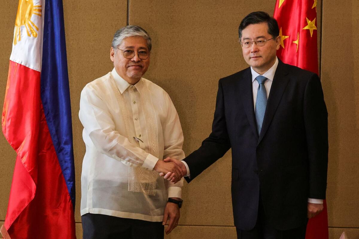 Chinese State Councilor and Foreign Minister Qin Gang and Philippine Foreign Affairs Secretary Enrique Manalo shake hands during the welcome ceremony prior to their bilateral meeting in Manila on Saturday. — Reuters