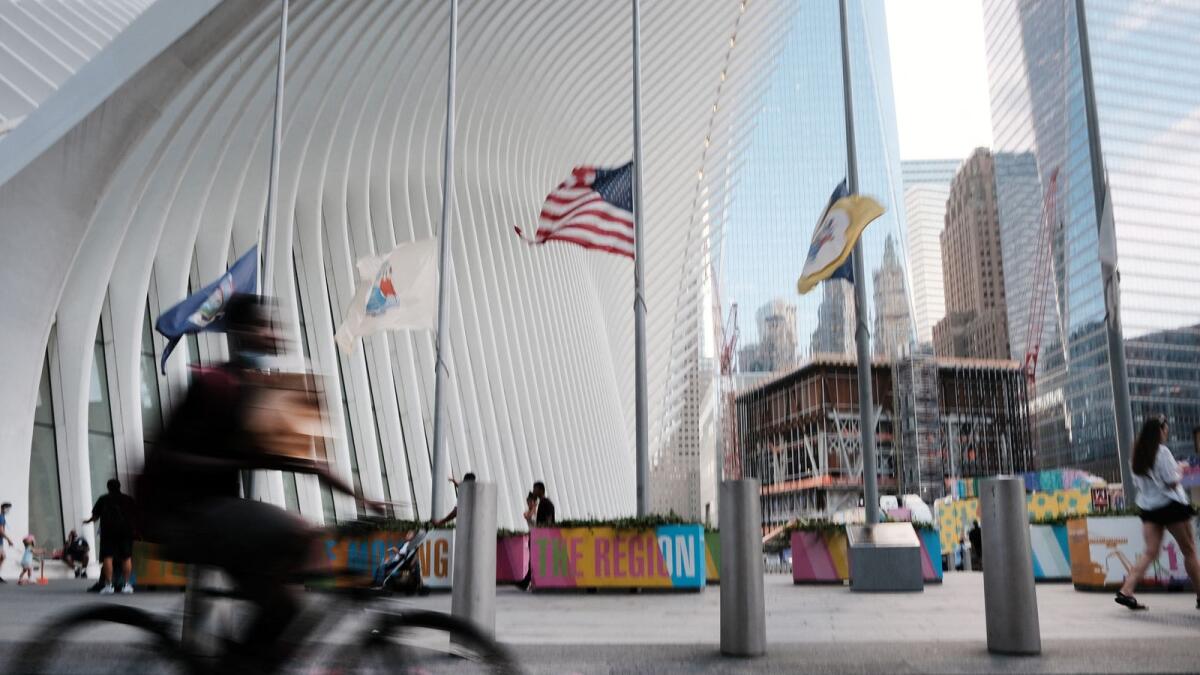 People walk and ride bikes near the sight of Ground Zero and the Freedom Tower in New York City. Photo: AFP