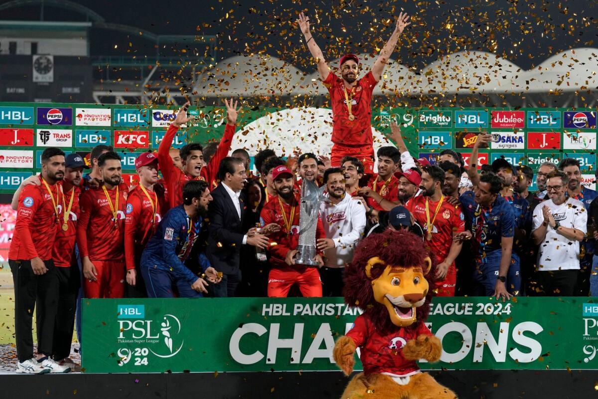 Islamabad United players and officials celebrate with the trophy. — AP