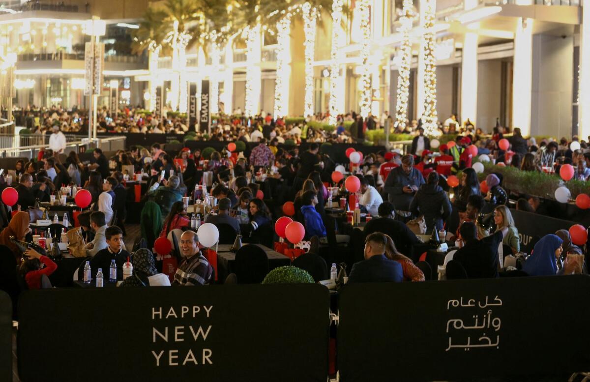 People gather outside the Burj Khalifa, the tallest building in the world, as they wait for the fireworks on the day of the New Year's Eve celebrations, in Dubai. Photo: Reuters