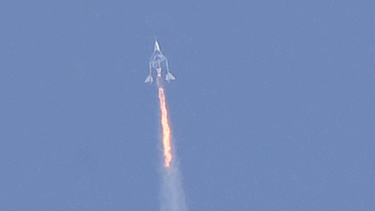 The Virgin Galactic SpaceShipTwo space plane Unity and mothership separate as they fly way above Spaceport America in 2021. — AFP file