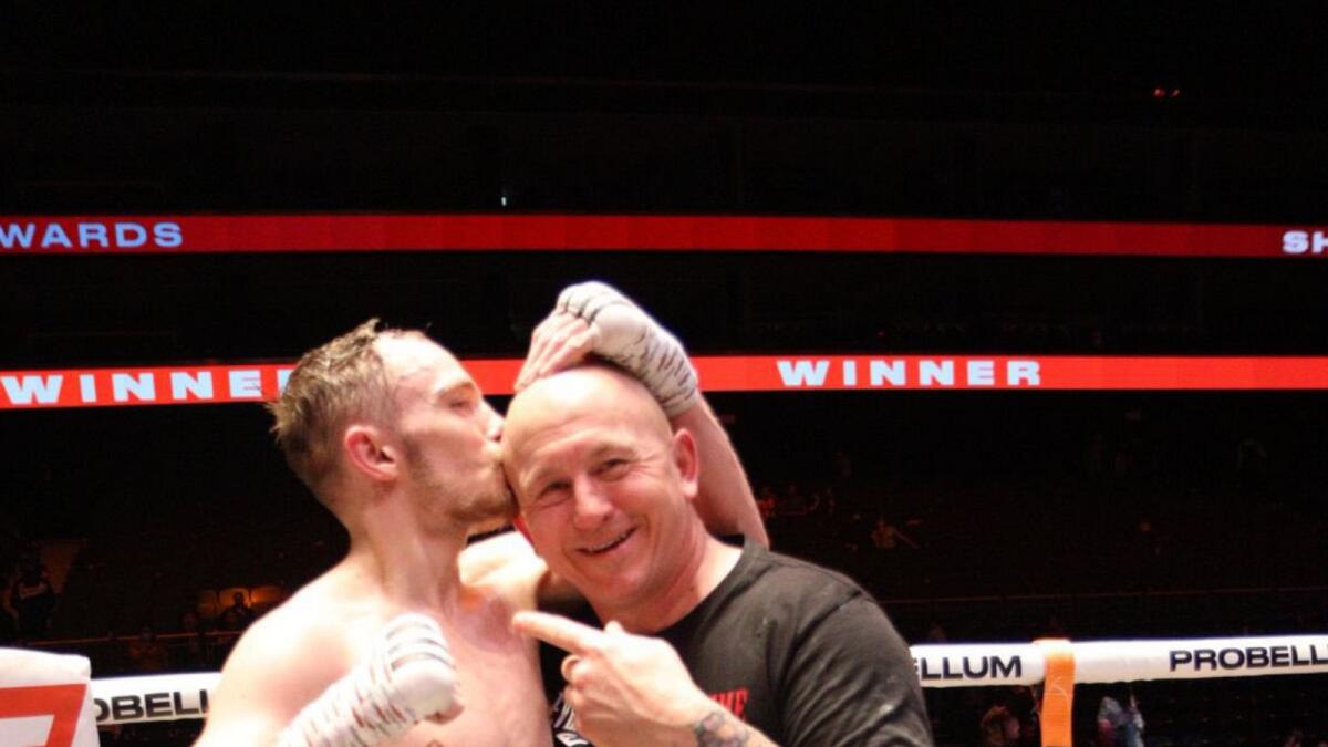 Sunny Edwards celebrates with head coach Grant Smith after defending his IBF title at the Coca Cola Arena in Dubai on Saturday night. (Twitter)