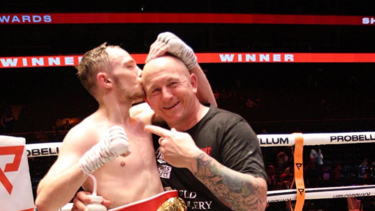 Sunny Edwards celebrates with head coach Grant Smith after defending his IBF title at the Coca Cola Arena in Dubai on Saturday night. (Twitter)