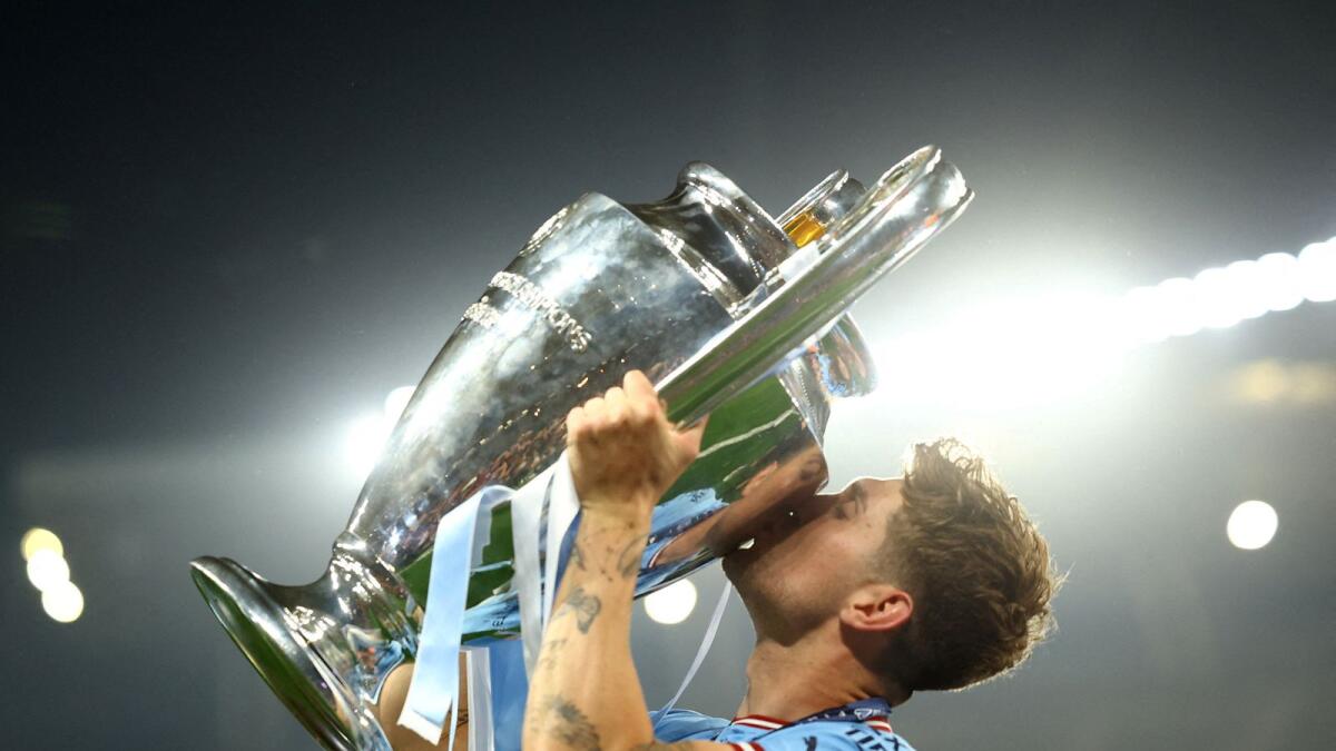 Manchester City's John Stones celebrates with the trophy after winning.