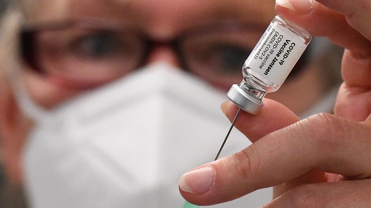 An assistant prepares a Johnson &amp; Johnson Janssen Covid-19 vaccine at a vaccination campaign in Berlin.– AFP