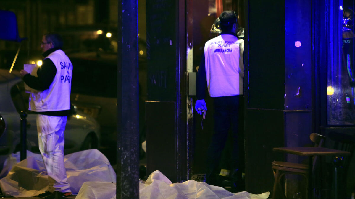 Victims lay on the pavement in a Paris restaurant, Friday, Nov. 13, 2015. AP photo