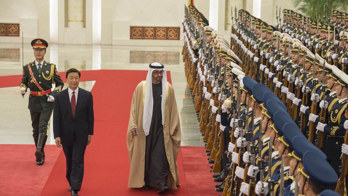 Shaikh Mohammed bin Zayed Al Nahyan and Li Yuanchao inspect a guard of honour at the Great Hall of the People in Beijing on Monday. — Wam photos