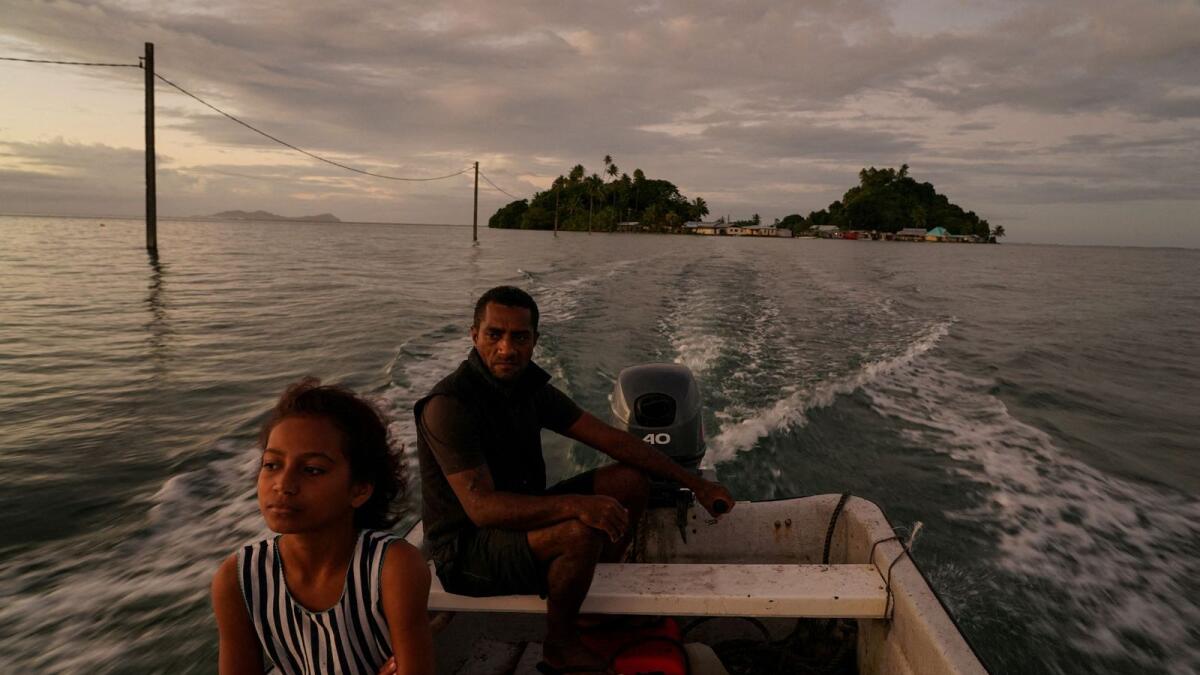A man drives his boat from Serua Island to the mainland at high tide  as rising sea level force Fiji villagers to relocate to higher ground, near Serua Village, Fiji, on July 14, 2022.  — Reuters file