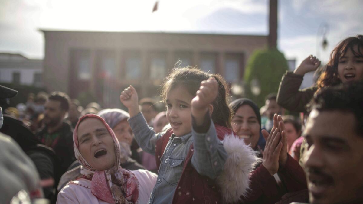 A child reacts as she is held by a family member during a protest against price hikes and commemorating the anniversary of the 2011 Arab Spring protests, in Rabat. — AP