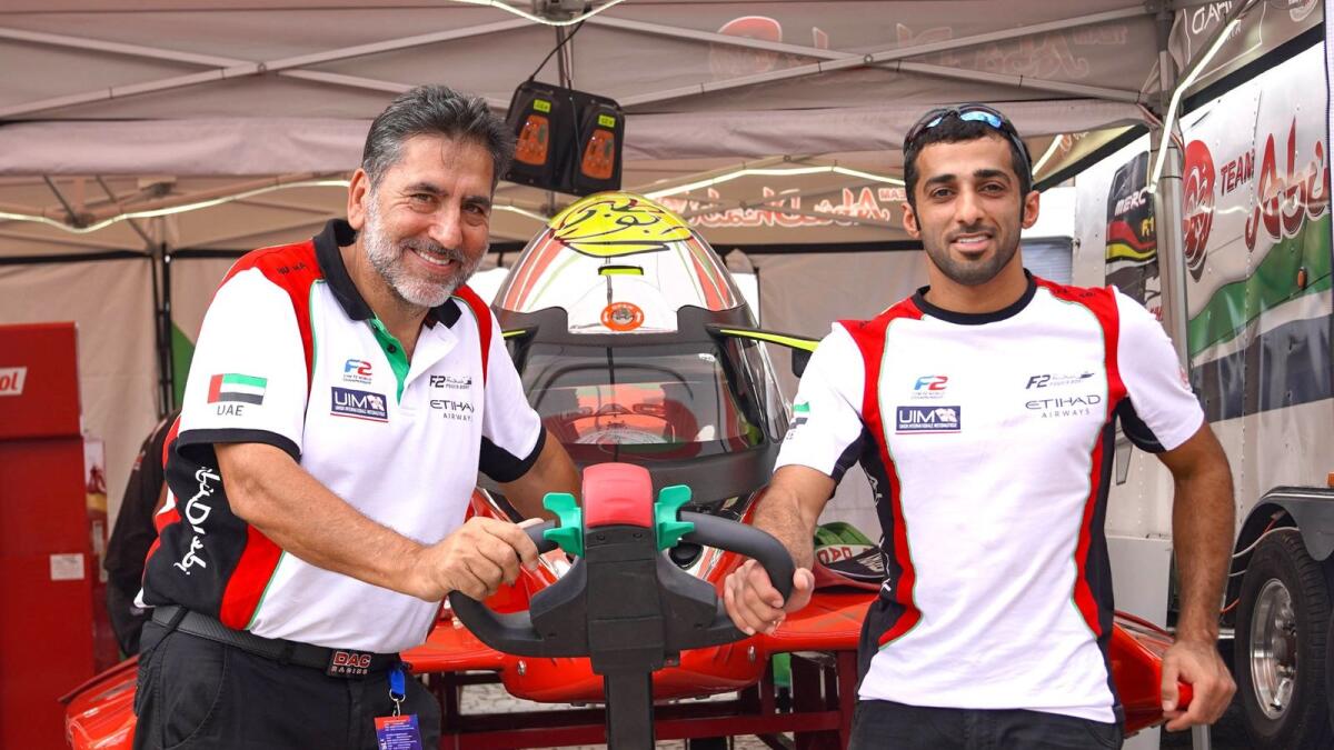 Rashed Al Qemzi with Team Abu Dhabi manager Guido Cappellini. - Supplied photo