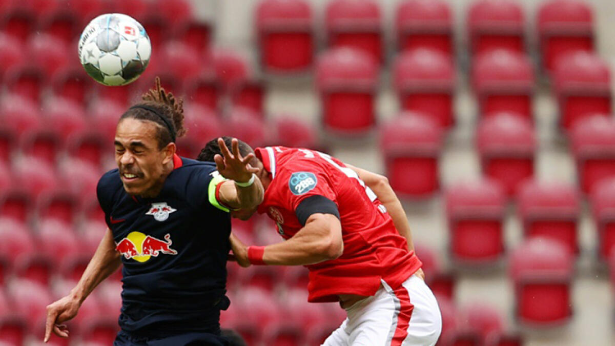 Leipzig's Danish forward Yussuf Poulsen (left) scored and set up two more goals against Mainz on Sunday despite suffering torn ankle ligaments. -- AFP