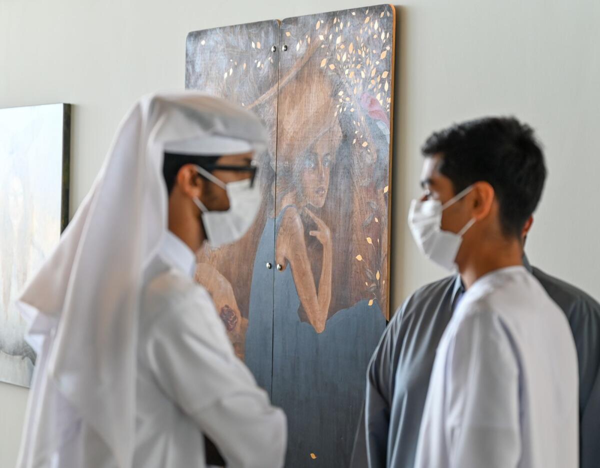 Visitors at Sharjah’s first NFT art exhibition, “Gateway to the Metaverse’’ hosted by House of Wisdom - Photo by M. Sajjad