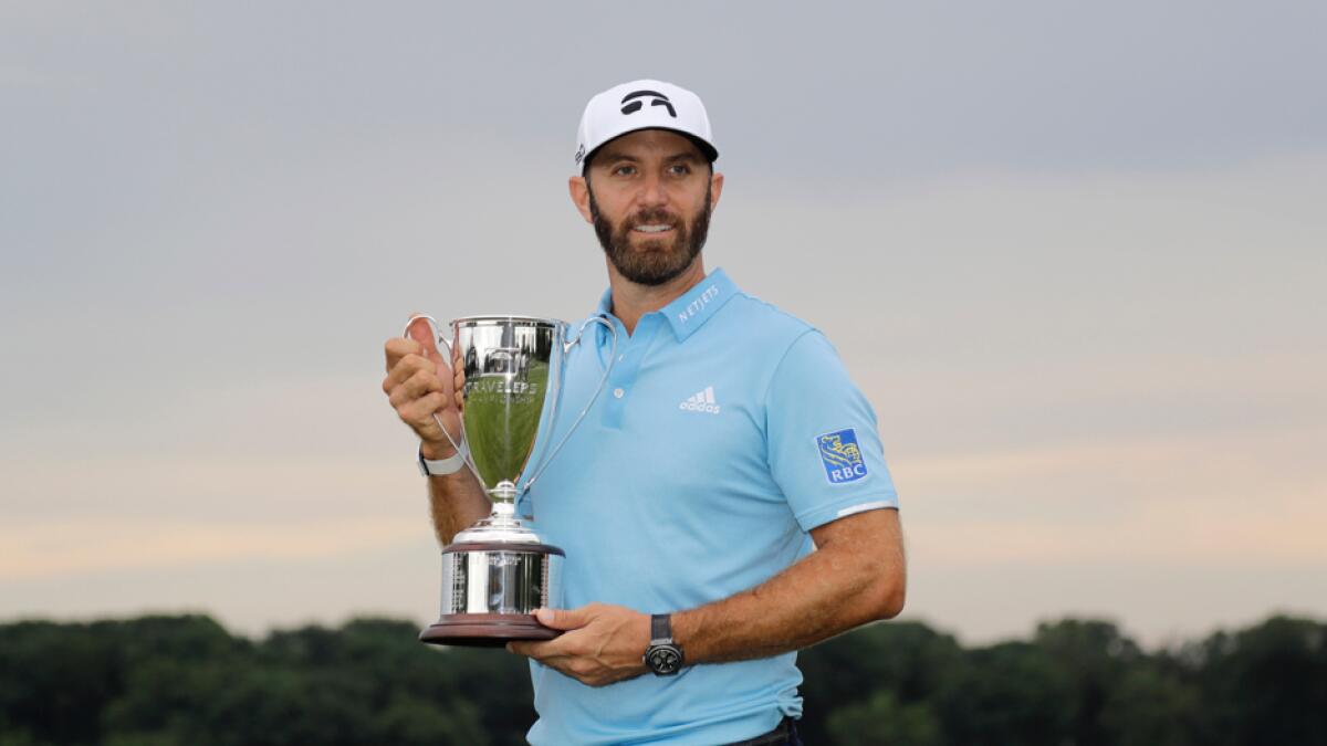 Dustin Johnson poses with the trophy after winning the Travelers Championship golf tournament at TPC River Highlands, Sunday, June 28, 2020, in Cromwell, Conn. Photo: AP