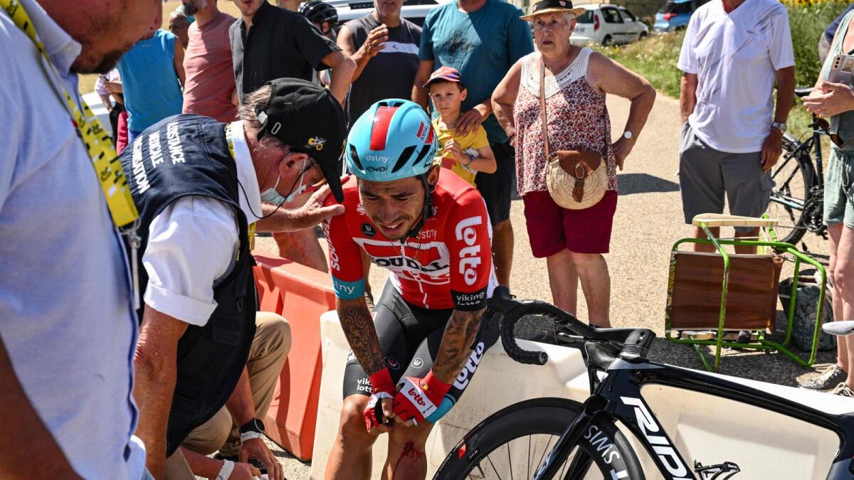 Lotto Soudal team's Australian rider Caleb Ewan receives medical attention after suffering a crash during the 13th stage of the Tour de France on Friday. — AFP