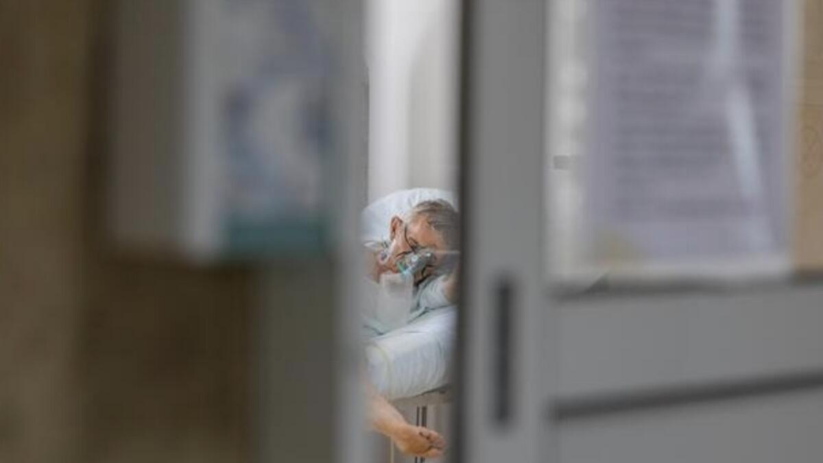A patient suffering from the coronavirus lies in bed at University Hospital Medical Center Bezanijska kosa in Belgrade, Serbia.