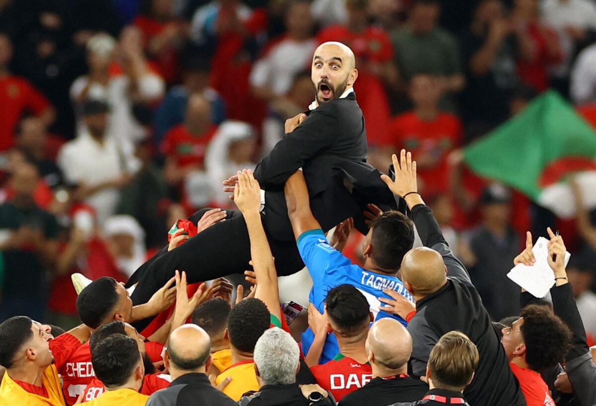 Morocco coach Walid Regragui celebrates with the players after the match as Morocco progress to the semi finals. Photo: REUTERS