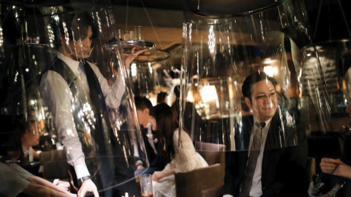 Goldfish bowl-like acrylic screens installed as part of new social distancing measures at Jazz Lounge Encounter, a night club for seeking encounters, in Tokyo's Ginza district, Japan, August 6.  Reuters