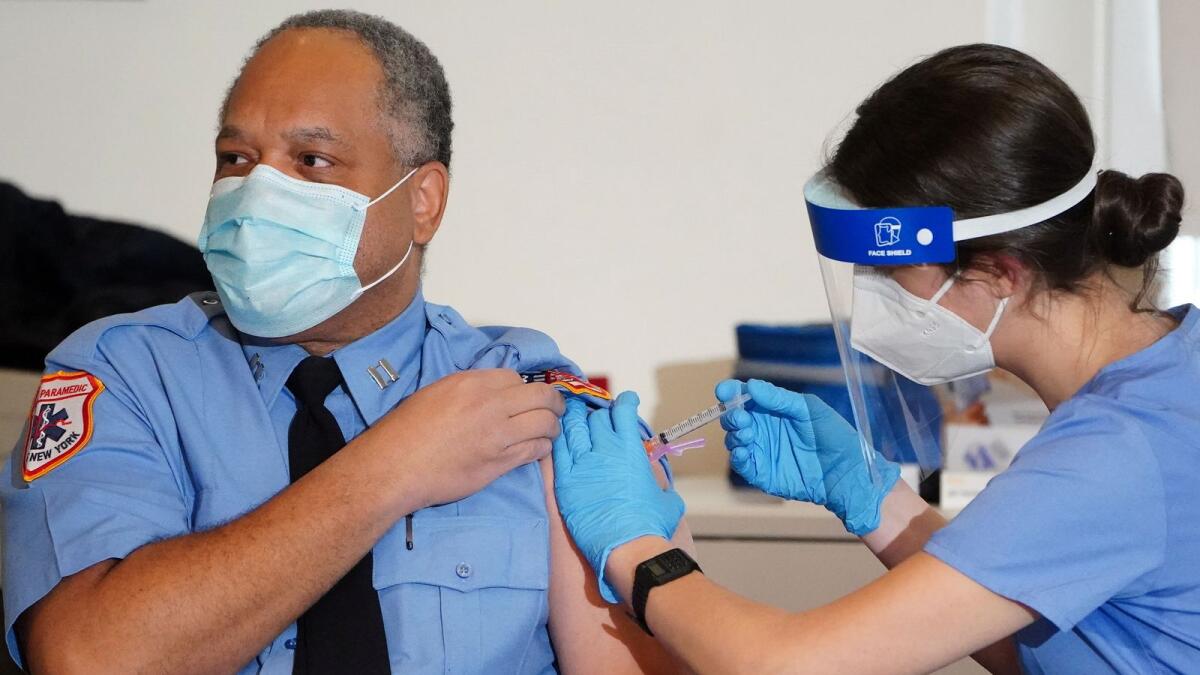 A worker of the New York City Fire Department Bureau of Emergency Medical Services (FDNY EMS) receives a COVID-19 Moderna vaccine, in New York, U.S., December 23, 2020.