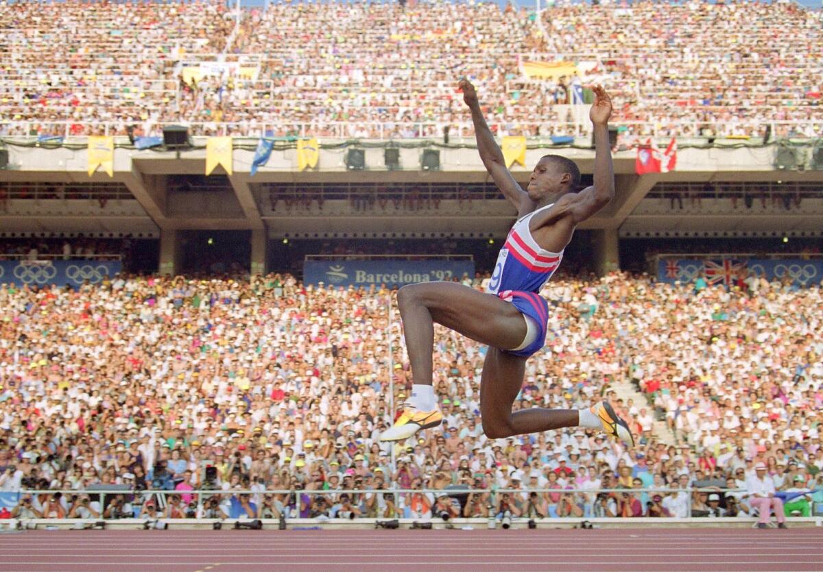 Carl Lewis of the USA flies through the air during the final of the men's long jump competition at the 1992 Barcelona Olympics. Lewis broke 13 world records in his career, won 9 Olympic gold medals and 8 world titles. — AFP file