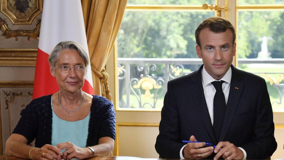 (FILES) In this file photo taken on June 27, 2018 French President Emmanuel Macron is seen with then French Transports Minister Elisabeth Borne (L). Photo: AFP