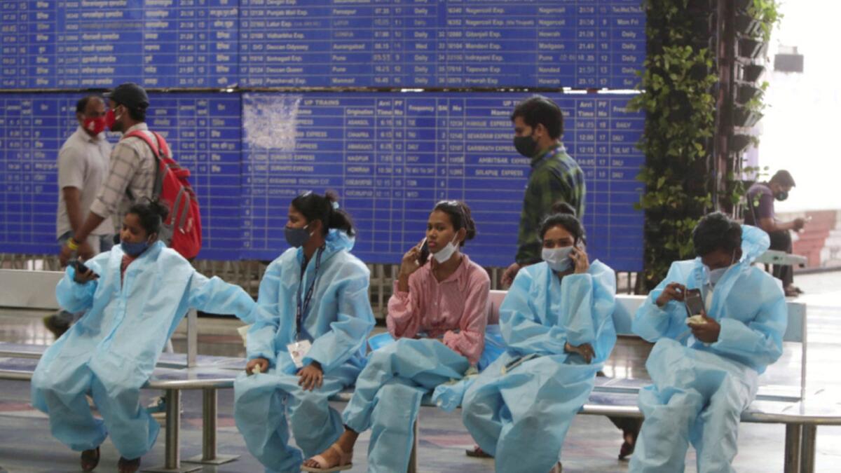Health workers wait to conduct Covid-19 tests on passengers coming by long distance trains at Chhatrapati Shivaji Maharaj Terminus in Mumbai. — AP
