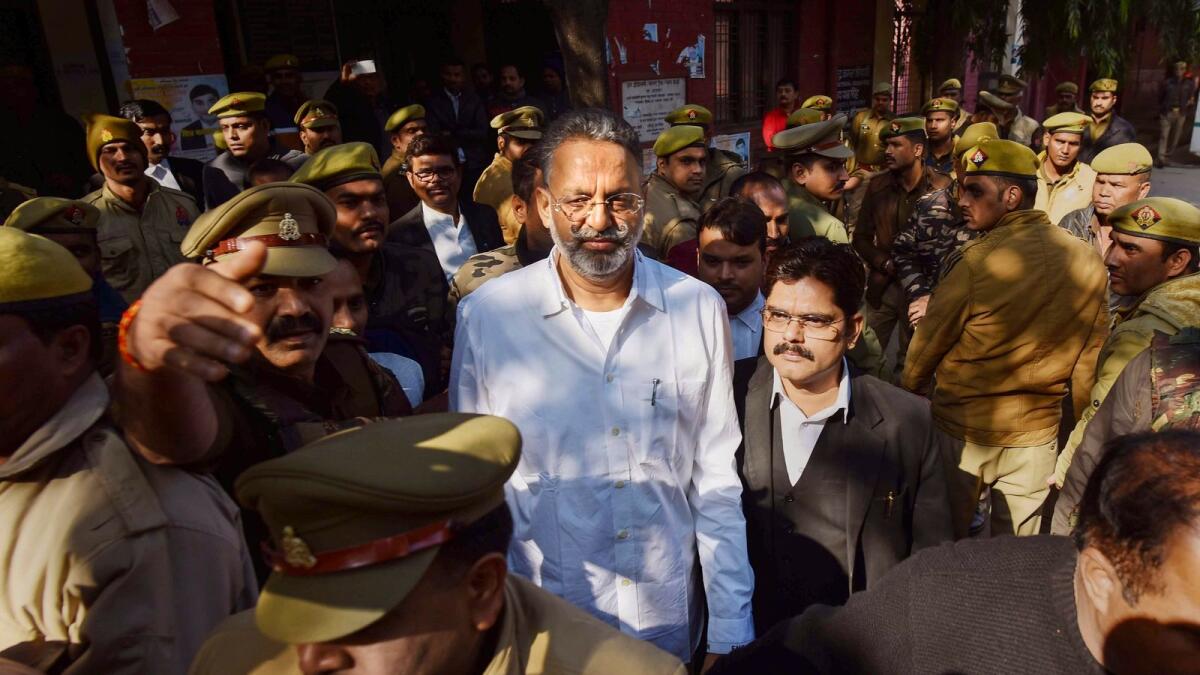Mukhtar Ansari (centre) is produced before a district court in Prayagraj. — PTI file