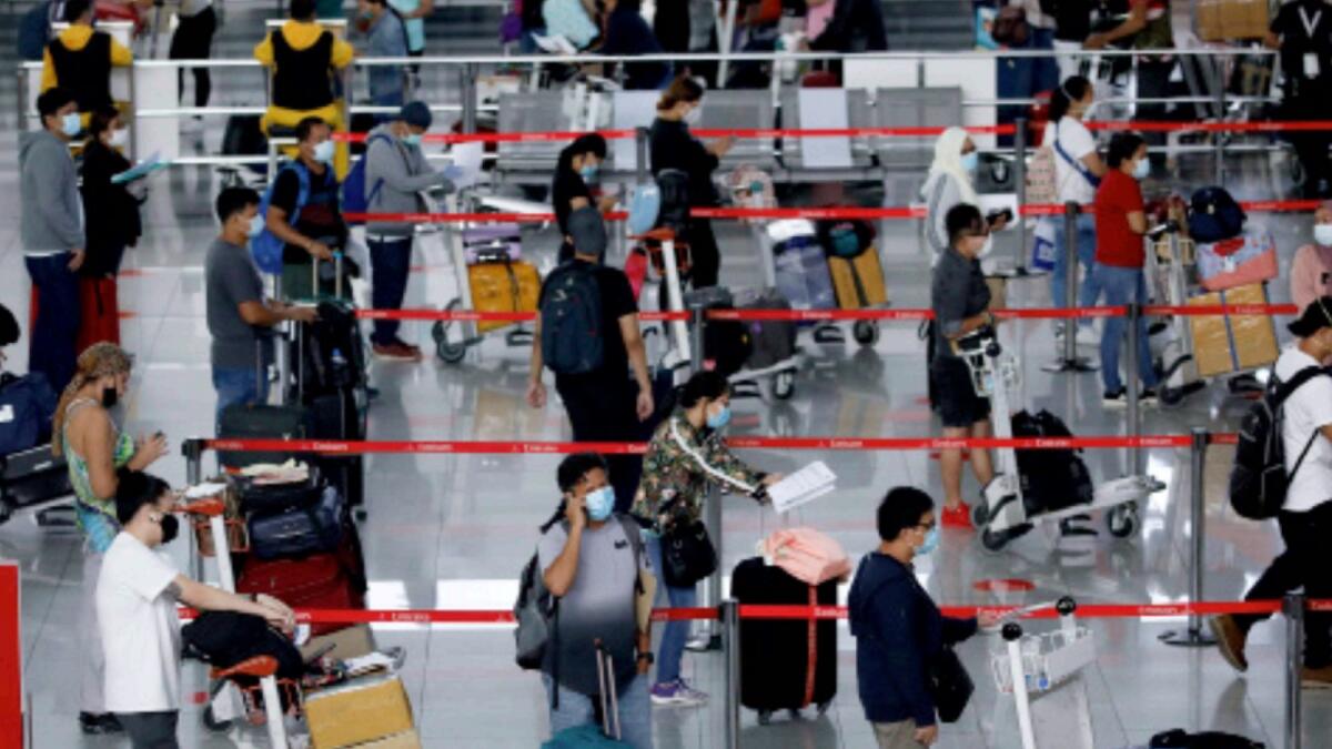 Passengers at Manila airport. — Reuters file