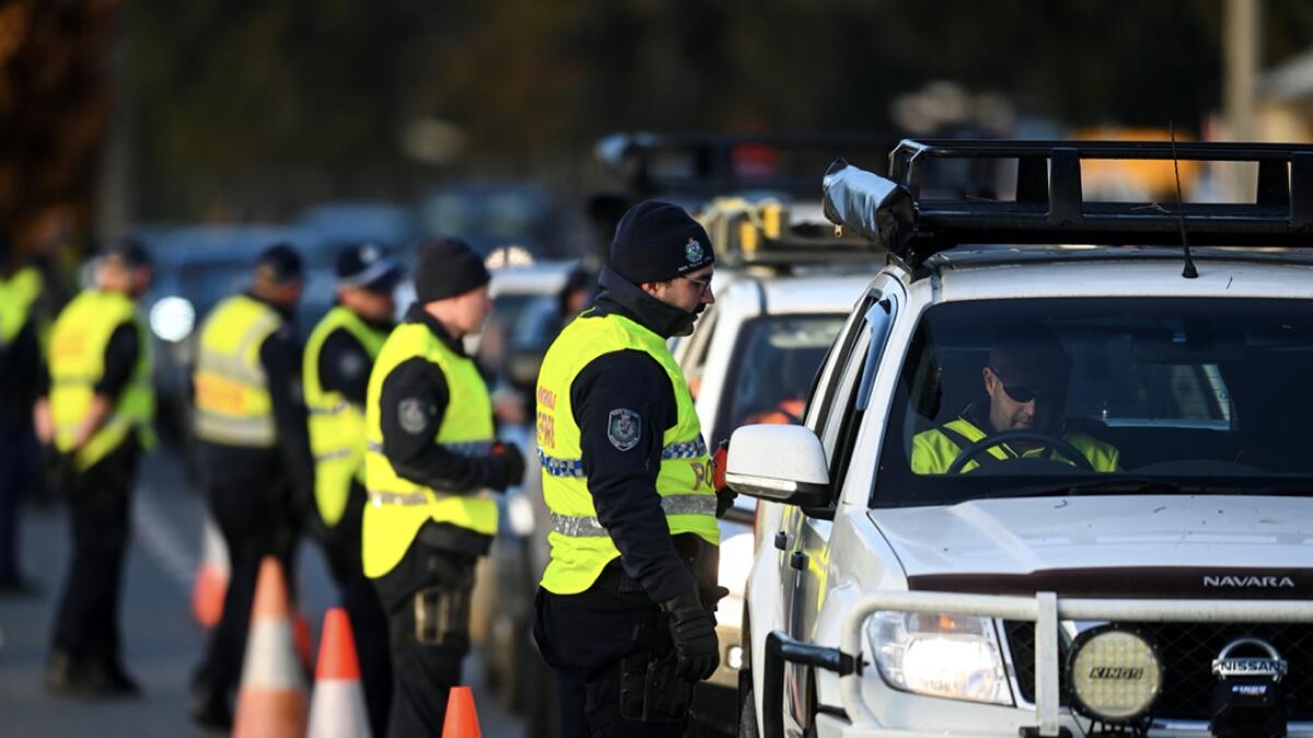 NSW police officers speak to drivers hoping to cross from the state of Victoria into New South Wales (NSW) at a border check point after the border was closed in response to a surge in coronavirus disease (Covid-19) cases in Victoria, in Albury, New South Wales, Australia. Photo: Reuters