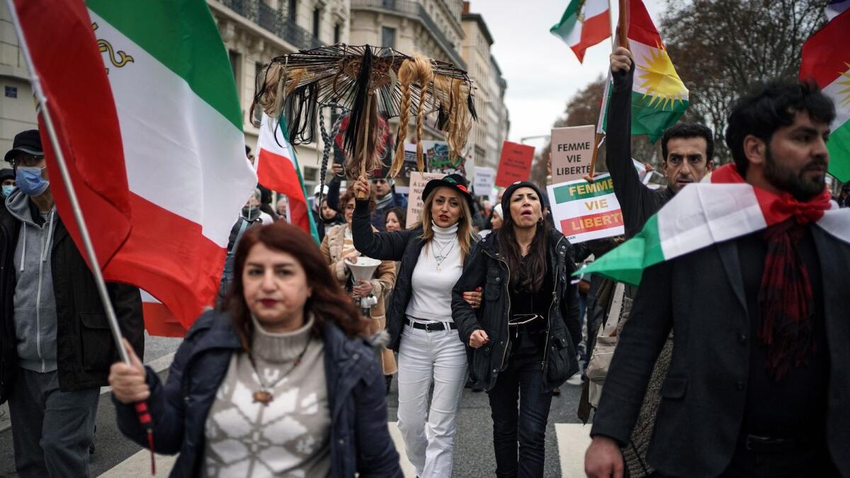 People demonstrate in Lyon, central France, on Sunday. Hundreds of people marched on Sunday in France to honour an Iranian Kurdish man who took his own life in a desperate act of anguish over the nationwide protests in Iran. — AP